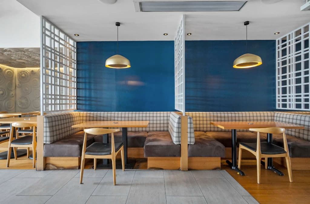 A booth seating area with blue shades and contemporary design.