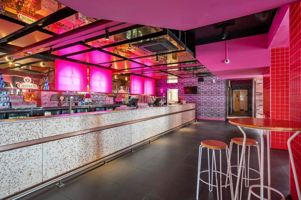Bright pinks deck out a bar in the nightclub upstairs.