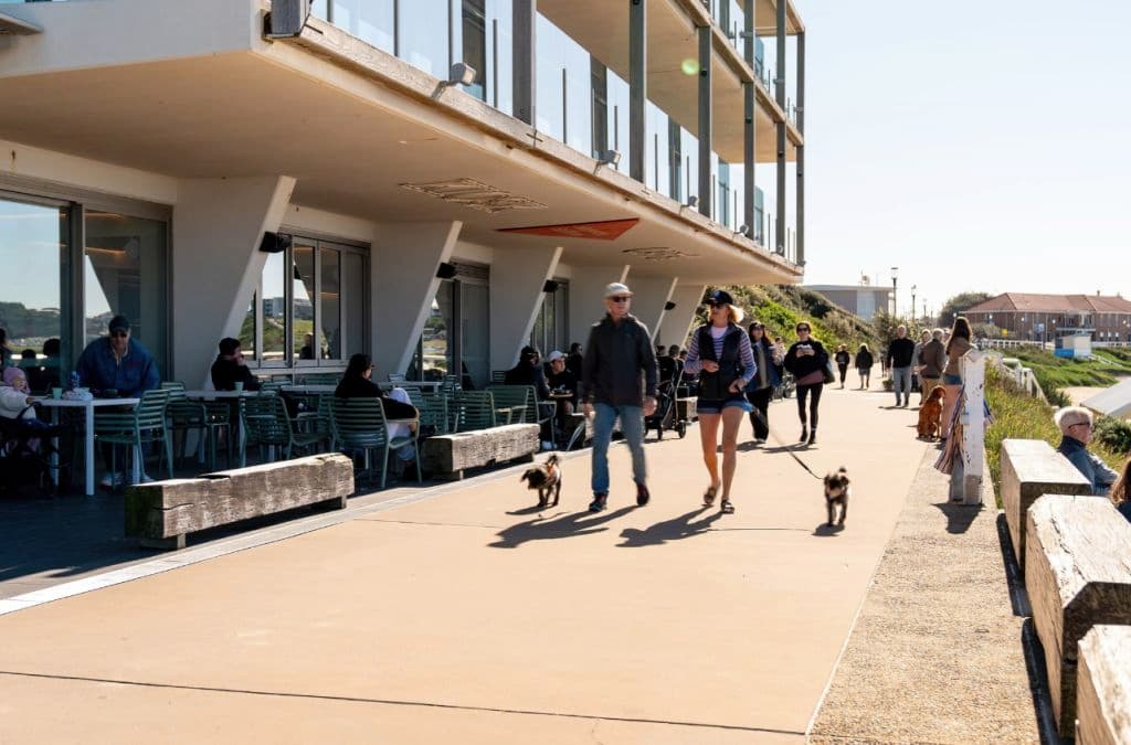 Walkers take dogs for a stroll outside the ground floor footpath outside the building.