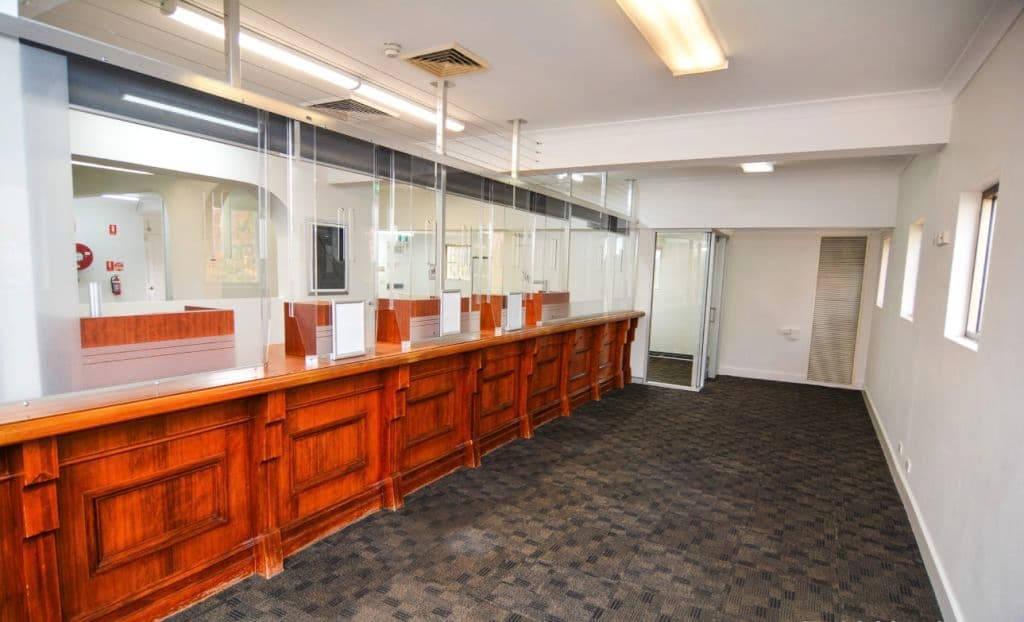 A timber bank teller lines the left side of the property's ground floor space.