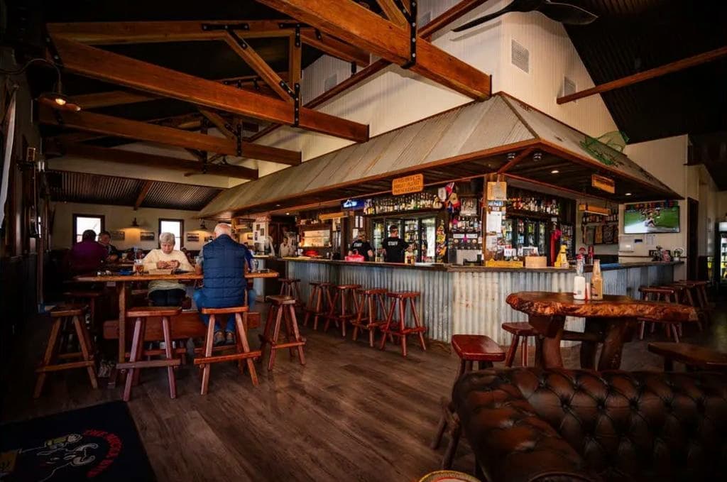 A tin-roof wraps its way around the long bar which is decked out with timber furniture.