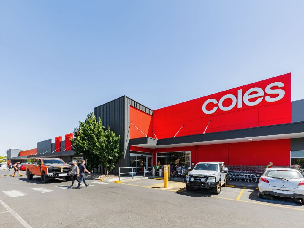 A modern, bright red building with Coles branded across it.