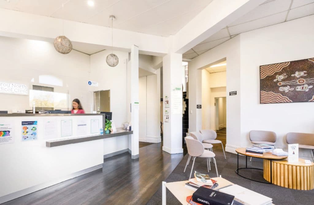 Inside the clinic's reception area with dark floors and modern touches.