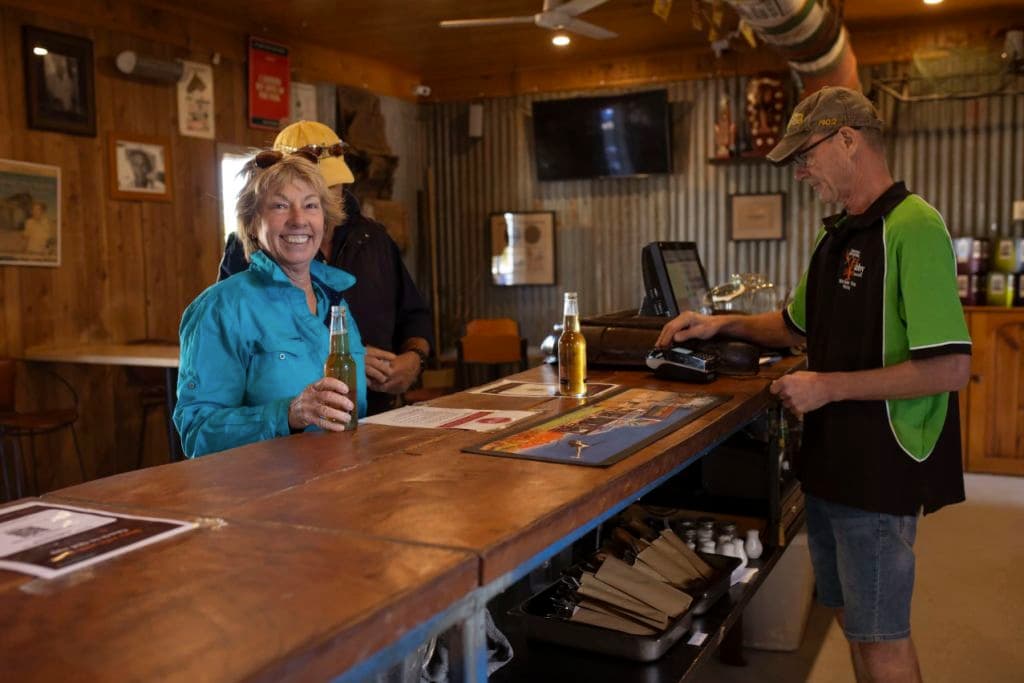 A woman smiles at the bar.