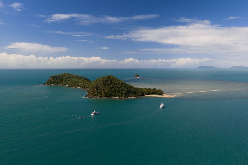 An aerial image of Double Island with boats in the water around it.