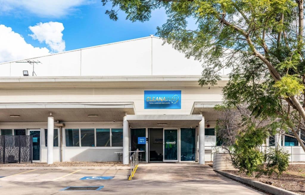 A white building with blue Cleanaway signage on the front.