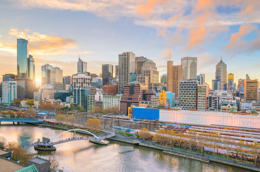 The Melbourne skyline at twilight shows the Yarra River.