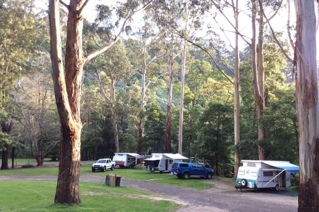 Some caravans and camp sites are positioned on the banks of the river.