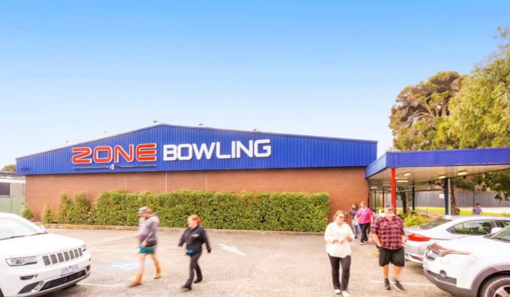 The Zone Bowling building with people out the front walking out to their cars.