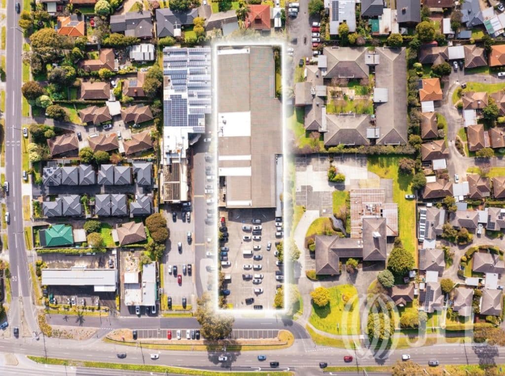 An aerial image of the property, showing a large land parcel and arterial road nearby.