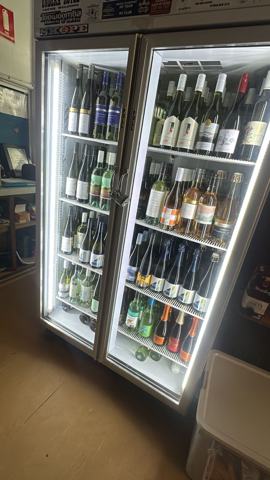 A fridge stocked with wine.