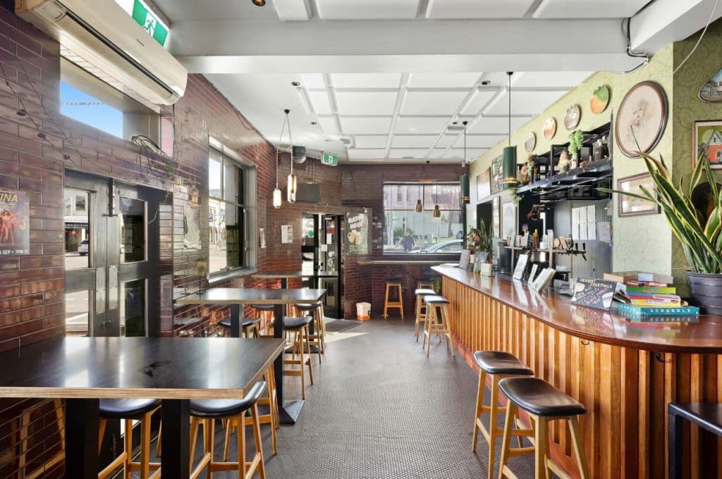 The pub's modern bar and tables are seen in this image inside.